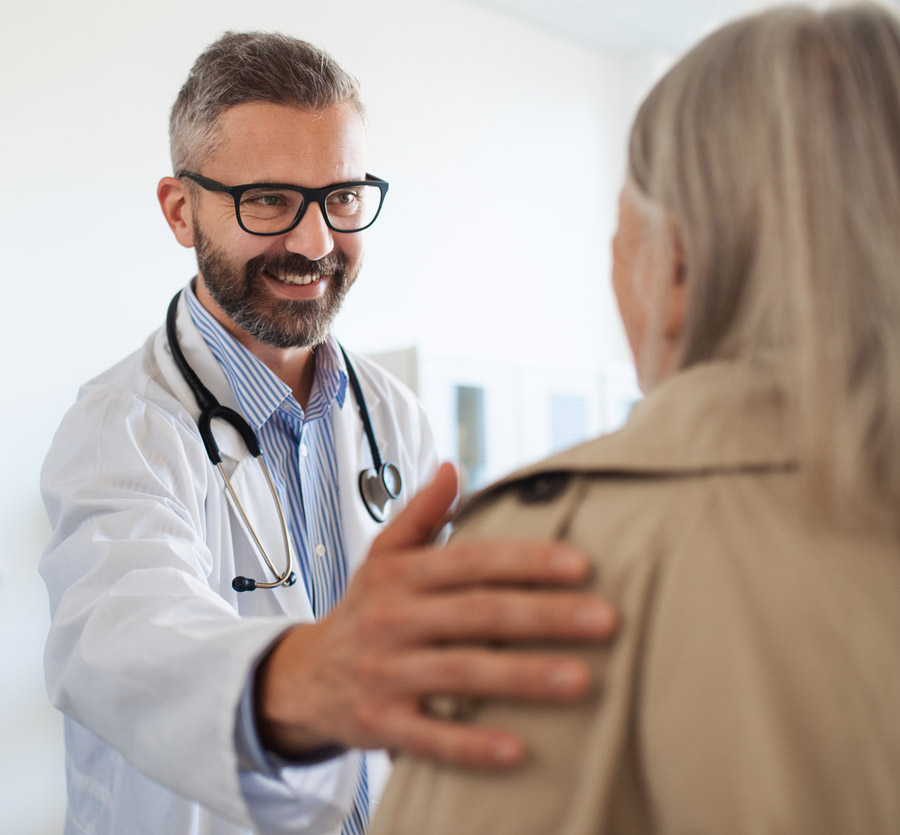 Caring doctor speaks with patient