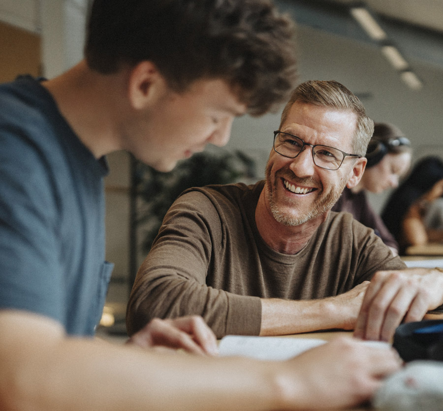 Adult helping child with paperwork