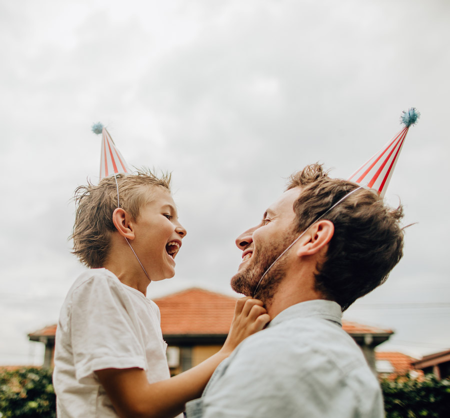 Father and son with birthday hats