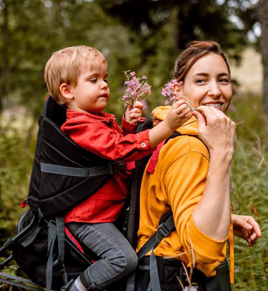 Mother with young son in a child carrier 