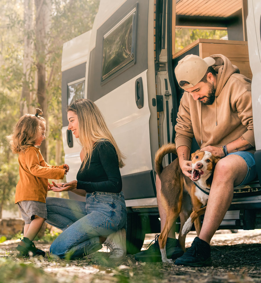Young family outside camping van 