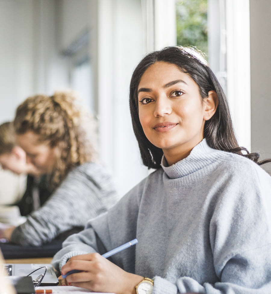 Young adult with pen in hand