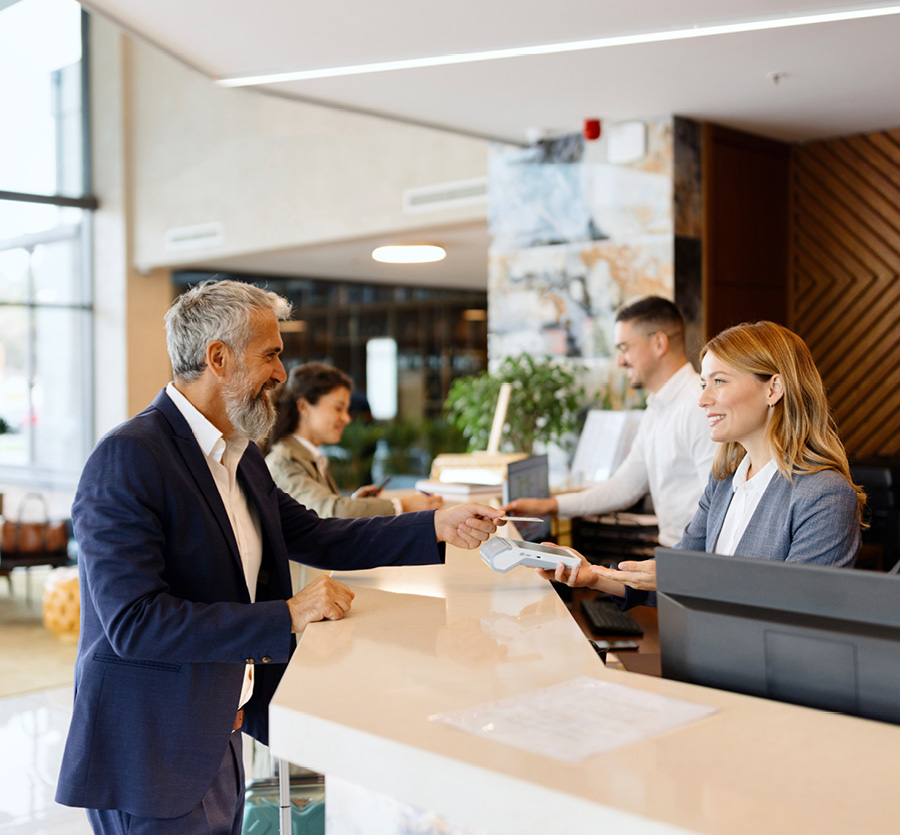 People checking in at a fancy hotel counter.