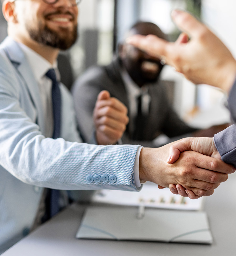 Close up of men shaking hands during a business meeting.