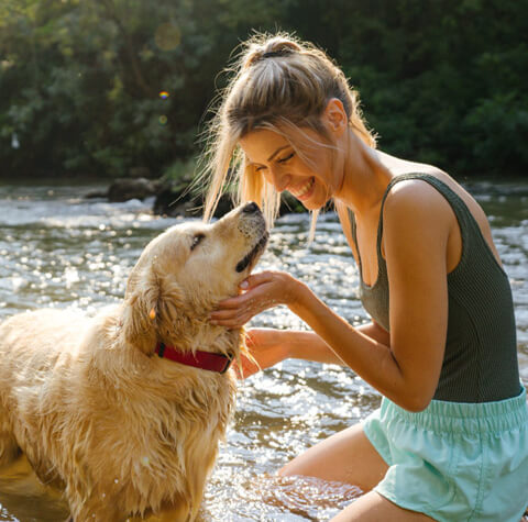 Woman with dog in river
