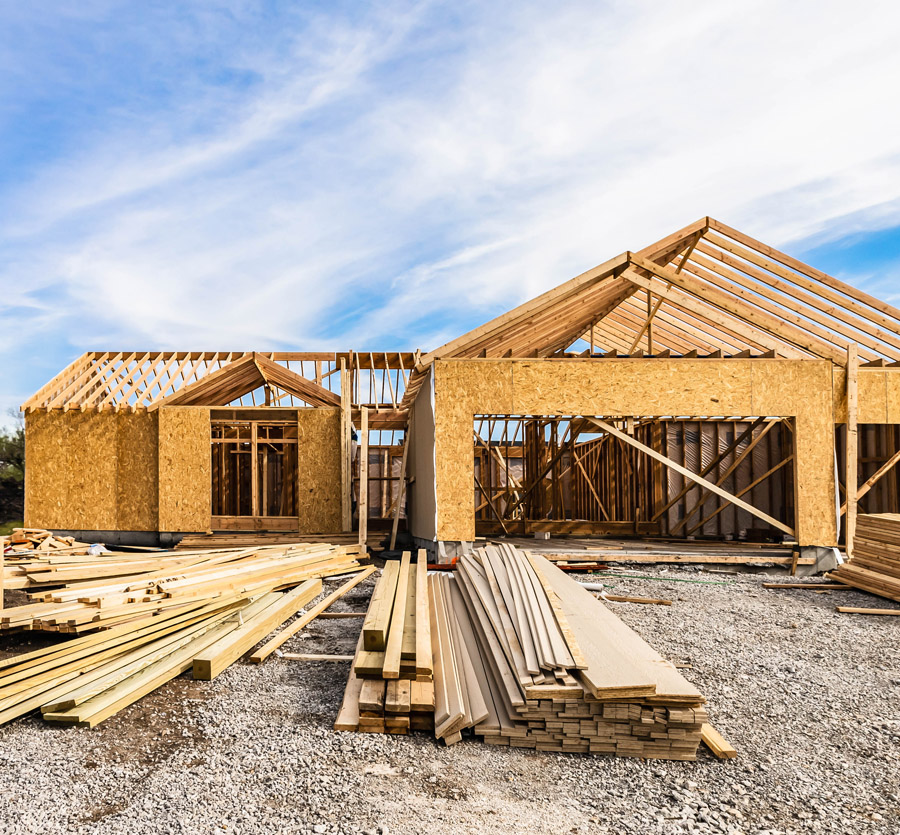 A framed house on a construction site.